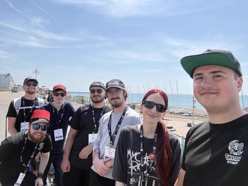 Four members of the Shiverbug Studios team on Brighton seafront during Develop:Brighton